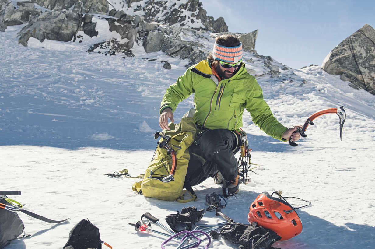 climbing equipment crouching on mountain